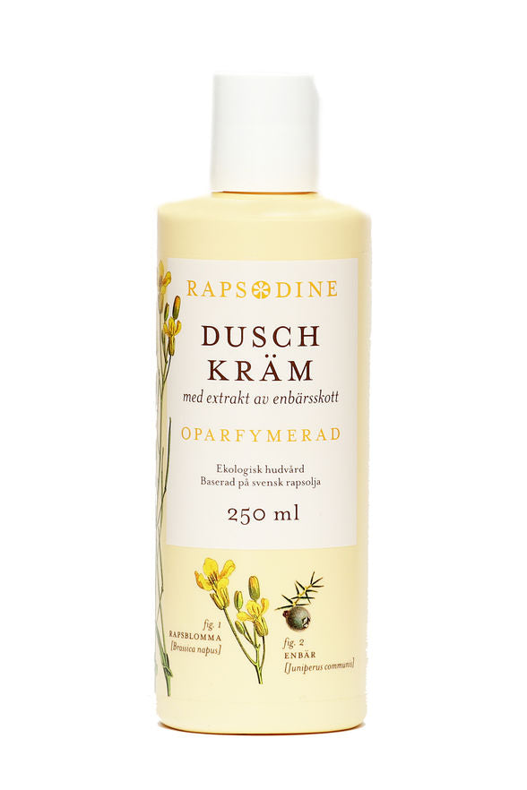250 ml Dushkräm i ljusgul förpackning. Cylinderformad med vitt lock. Oparfymerad. Rapsblommor i gul färg och blå enbär målade. Rapsodine i gul text överst på förpackning.