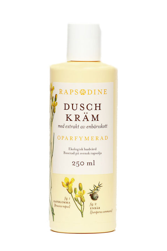 250 ml Dushkräm i ljusgul förpackning. Cylinderformad med vitt lock. Oparfymerad. Rapsblommor i gul färg och blå enbär målade. Rapsodine i gul text överst på förpackning.